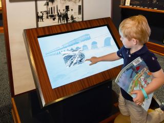 Young child at a touchscreen display at the Mote Marine Laboratory Coral Reef Exploration Exhibit