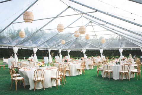 A Large Tent With Tables And Chairs